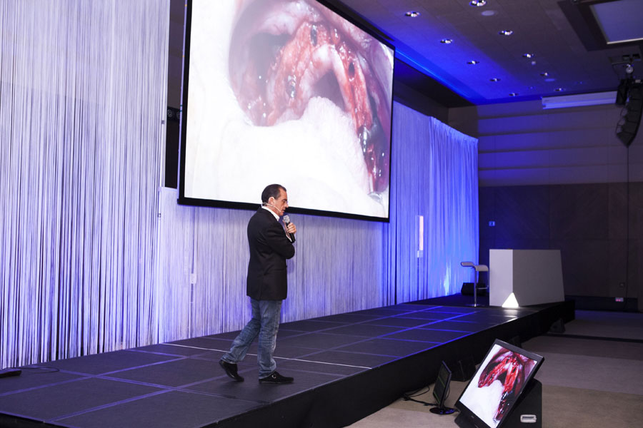 Dr. Carlos Aparicio comentando la cirugía en directo de implantes cigomáticos del Dr. Rubén Davó
