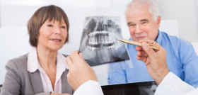 Dentist Explaining X-Ray To Senior Couple