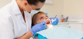 young boy getting his teeth examined