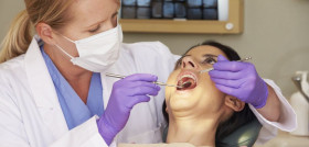 Woman Having Check Up At Dentists Surgery