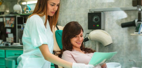 Dentist examining patient's teeth X-Ray image in dental office.