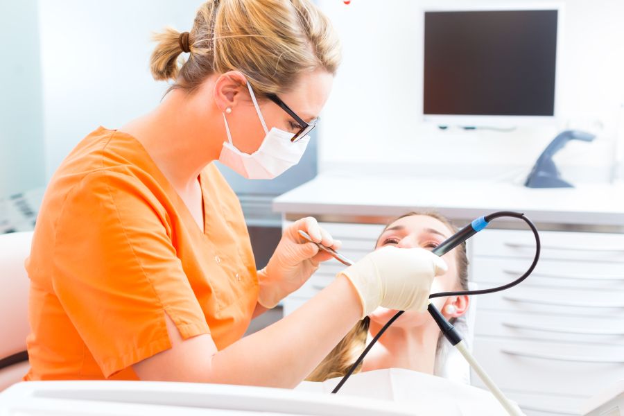 Patient having dental tooth cleaning at dentist