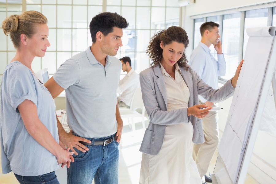 Pregnant businesswoman presenting her ideas in the office